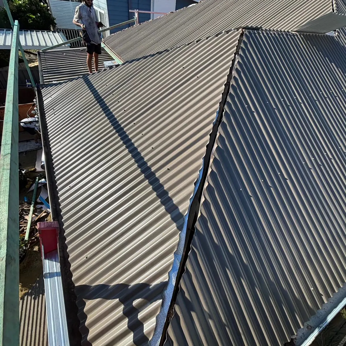 Long runs of dark corrugated sheeting on a finished roof