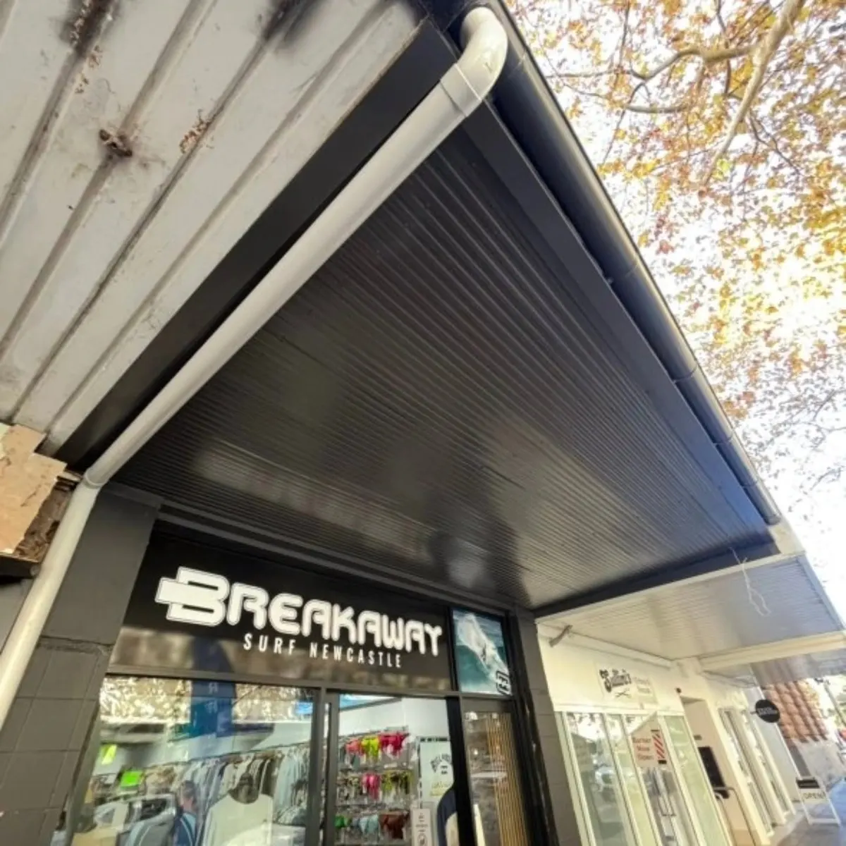 Shopfront awning finished with a dark lined soffit